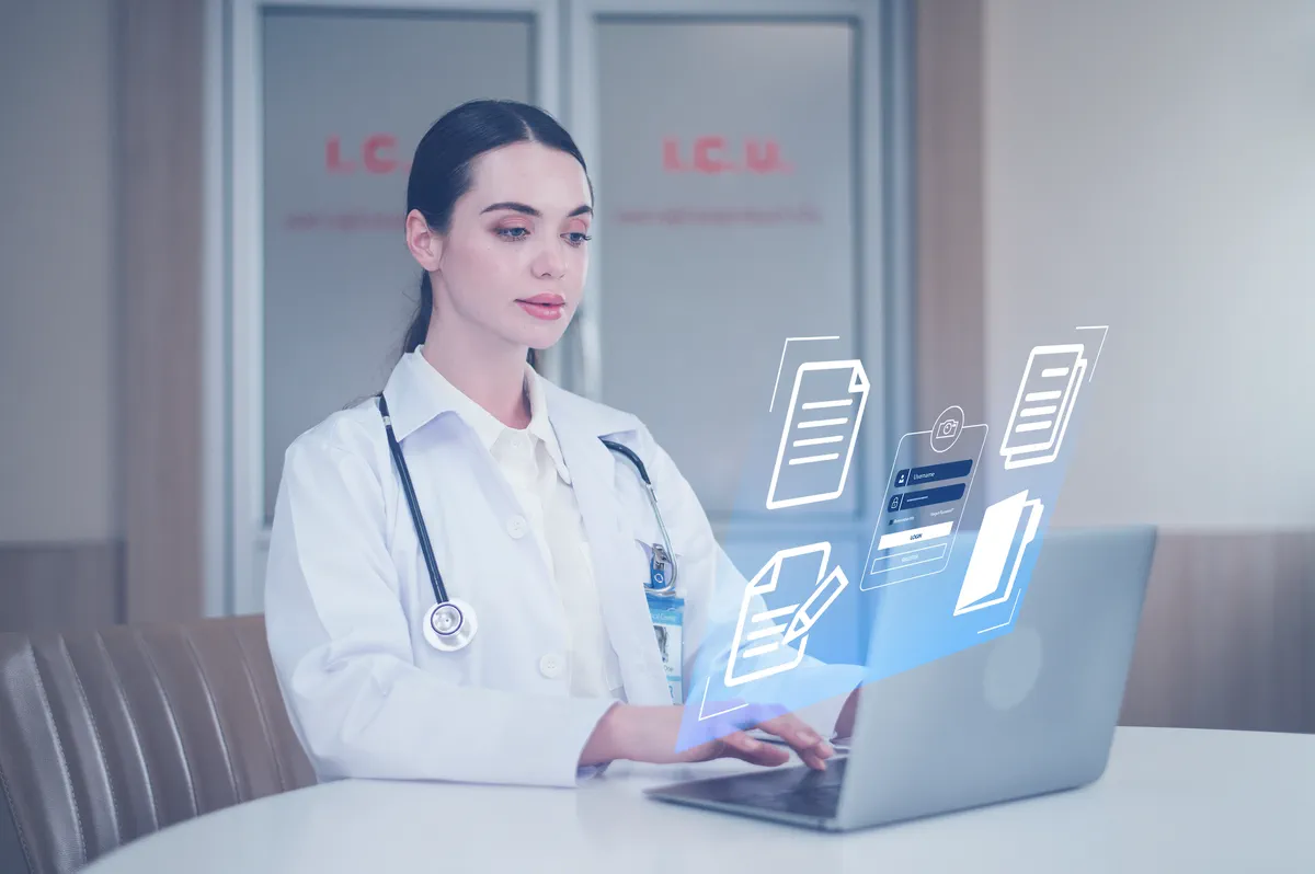Doctor at a laptop reviewing patient records during a virtual visit